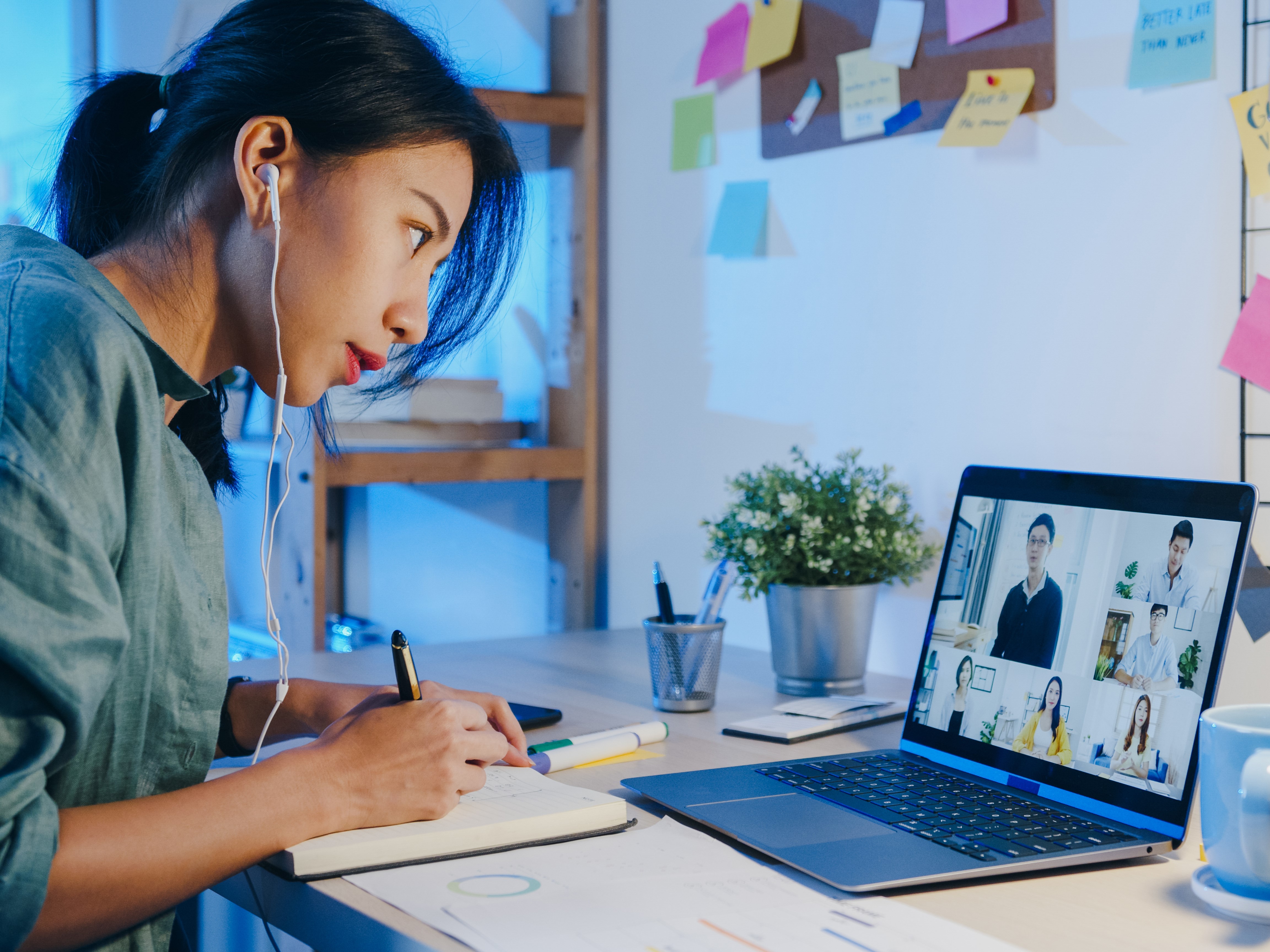 asia businesswoman using laptop talk colleagues about plan video call meeting living room